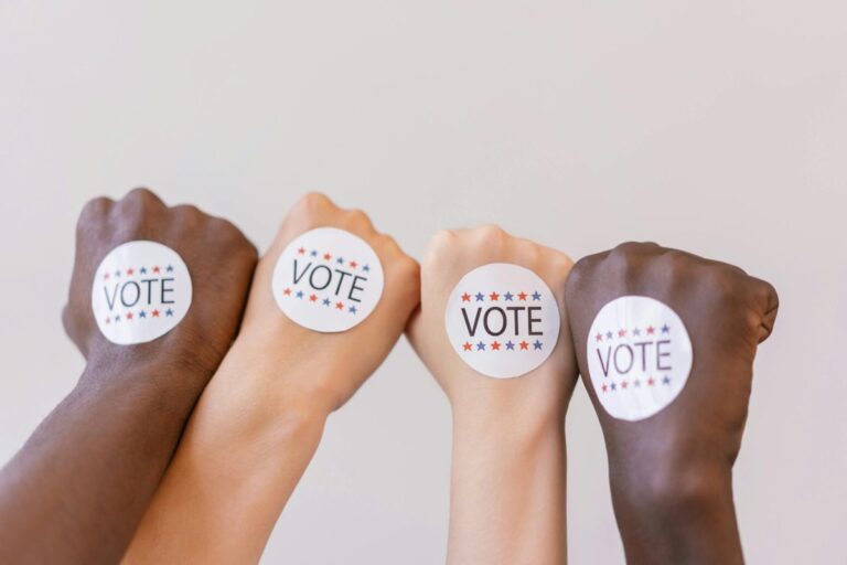 A group of four raised fists, each with a
