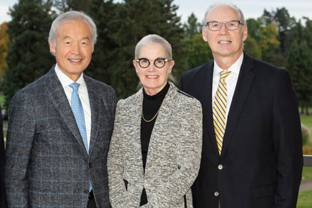 Photo of two men and a woman.