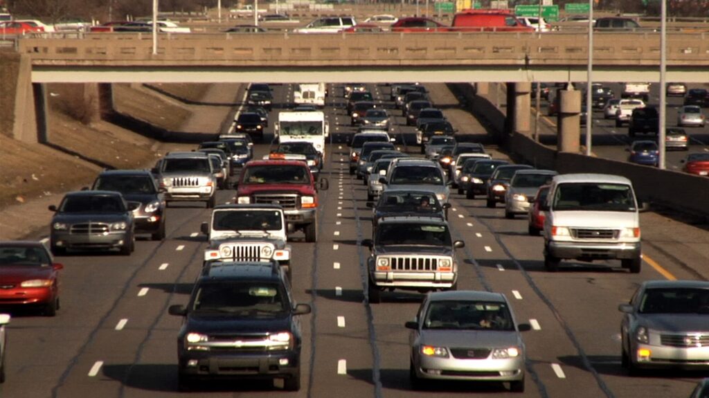 Four lanes of heavy traffic move toward the camera.