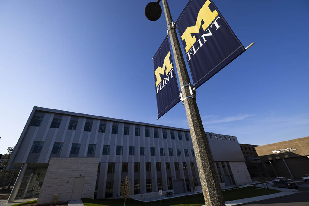 Principal investigators Ken Sylvester (left) and Mohamed Wiem Mkaouer discussed the implications of new NSF funding at a faculty meeting on the UM-Flint campus, Jan. 10.