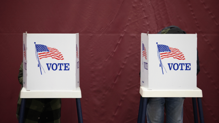 Two white voting booths with bold