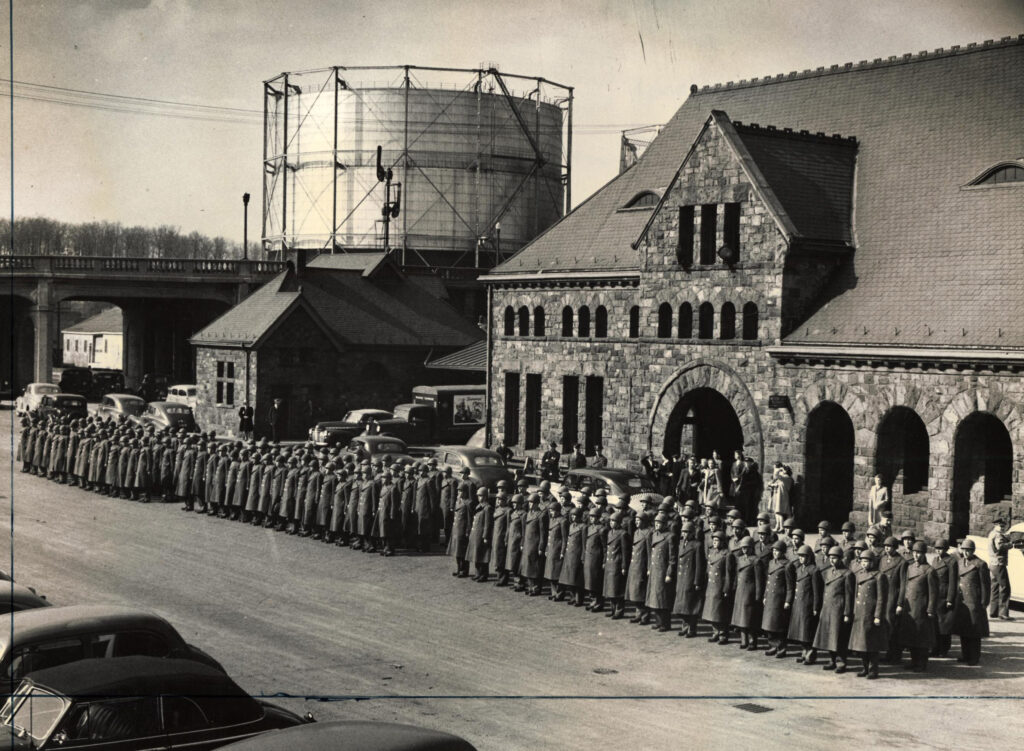 Army units stand at attention outside the Ann Arbor train station, circa 1941-44. 