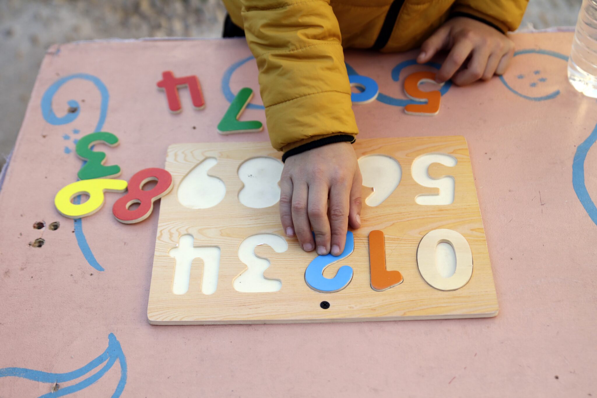 A boy plays with a wooden numbers puzzle. Sensory exercises like this are often used in special education classrooms. (Getty Images)