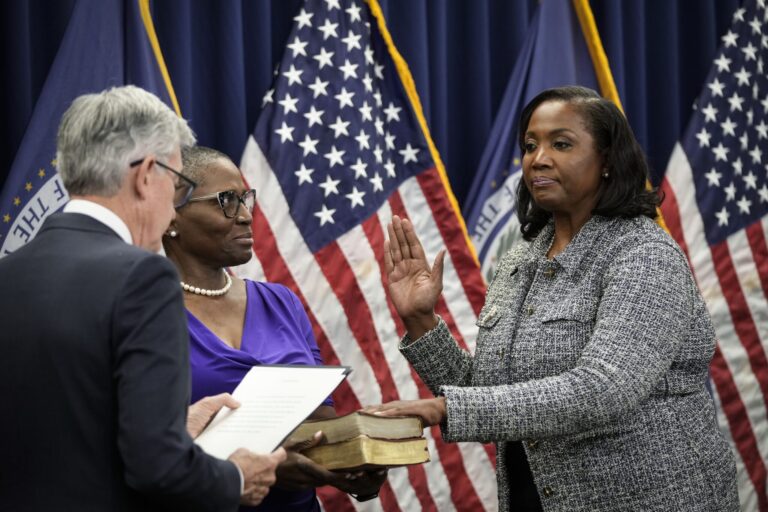 Chair of the Federal Reserve Jerome Powell, left, administers the oath of office to Lisa Cook, right, to serve as a member of the Board of Governors at the Federal Reserve System during a ceremony at the William McChesney Martin Jr. Building of the Federal Reserve May 23, 2022 in Washington, D.C.  (Photo by Drew Angerer/Getty Images)