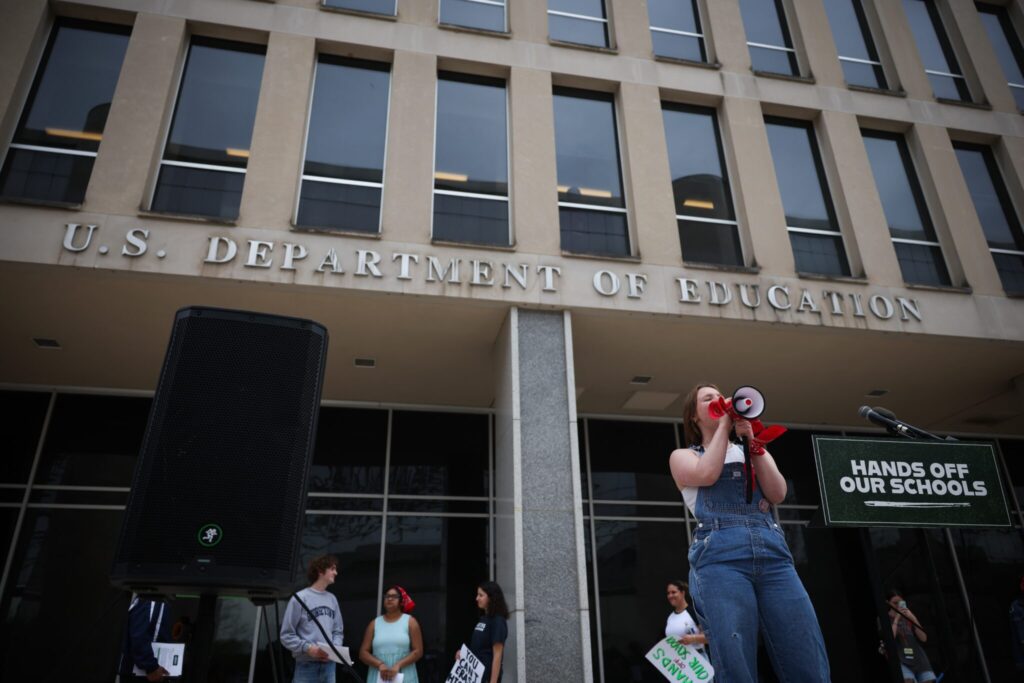 Student protesters shout during a “Hands Off Our Schools” rally in front of the U.S. Department of Education building in Washington, D.C., in April. The same group held a virtual press conference Tuesday to protest President Donald Trump’s efforts to dismantle the U.S. Department of Education. (Photo by Kayla Bartkowski/Getty Images)