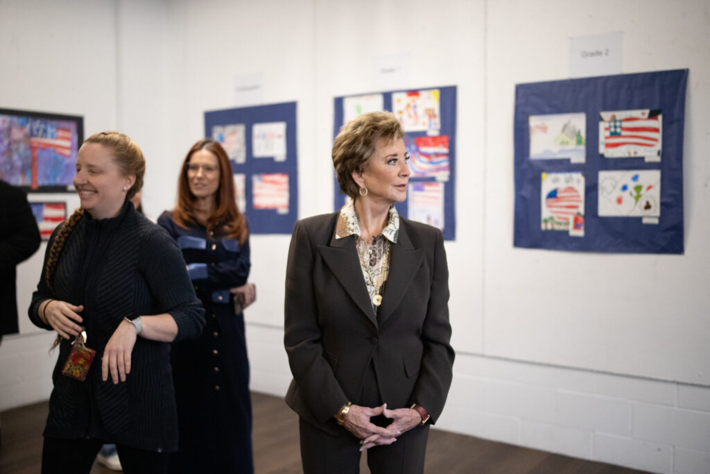 U.S. Education Secretary Linda McMahon takes in a selection of grade school students’ patriotic artworks and high schoolers’ recent output in a special installation set up at Exeter-West Greenwich Regional Junior High and High School in Rhode Island on Monday, Jan. 12, 2026. (Photo by Alexander Castro/Rhode Island Current)