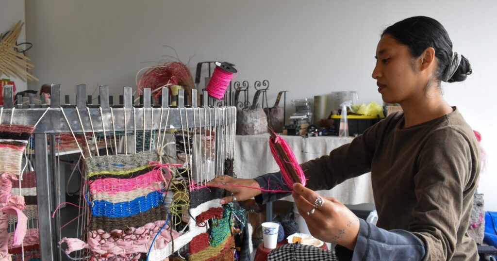 This artist built a big steel loom in downtown Phoenix. Everyone is welcome to weave on it