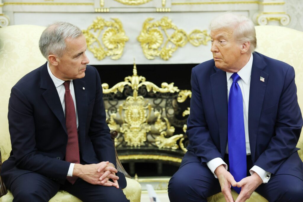President Donald Trump, right, and Canadian Prime Minister Mark Carney speak to reporters in the Oval Office of the White House on Oct. 7, 2025 in Washington, D.C.  (Photo by Anna Moneymaker/Getty Images)