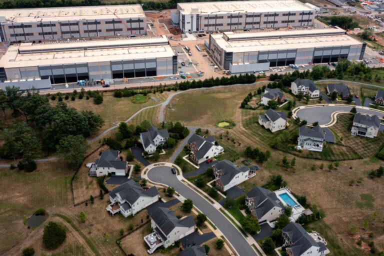 An Amazon Web Services data center is shown situated near single-family homes in Stone Ridge, Va., in 2024. As Americans grow increasingly frustrated over their electricity bills, states are trying to keep the nation’s growing number of data centers from causing higher energy costs for consumers.