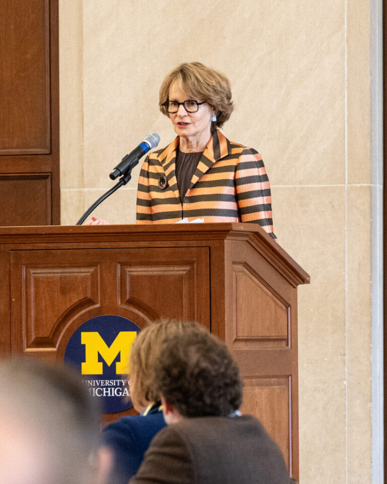 U-M Provost Laurie McCauley speaking at a podium