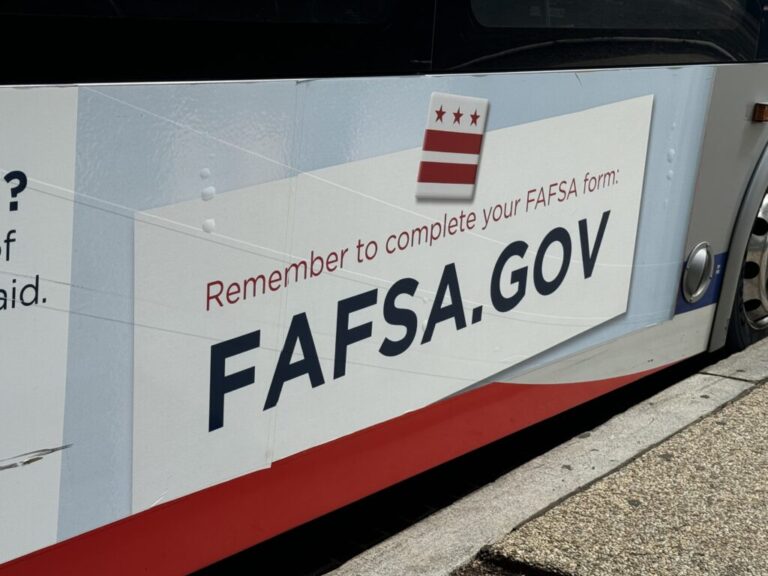 A sign reminding people to complete the Free Application for Federal Student Aid — better known as FAFSA — appears on a bus near Union Station in Washington, D.C. (Shauneen Miranda/States Newsroom)