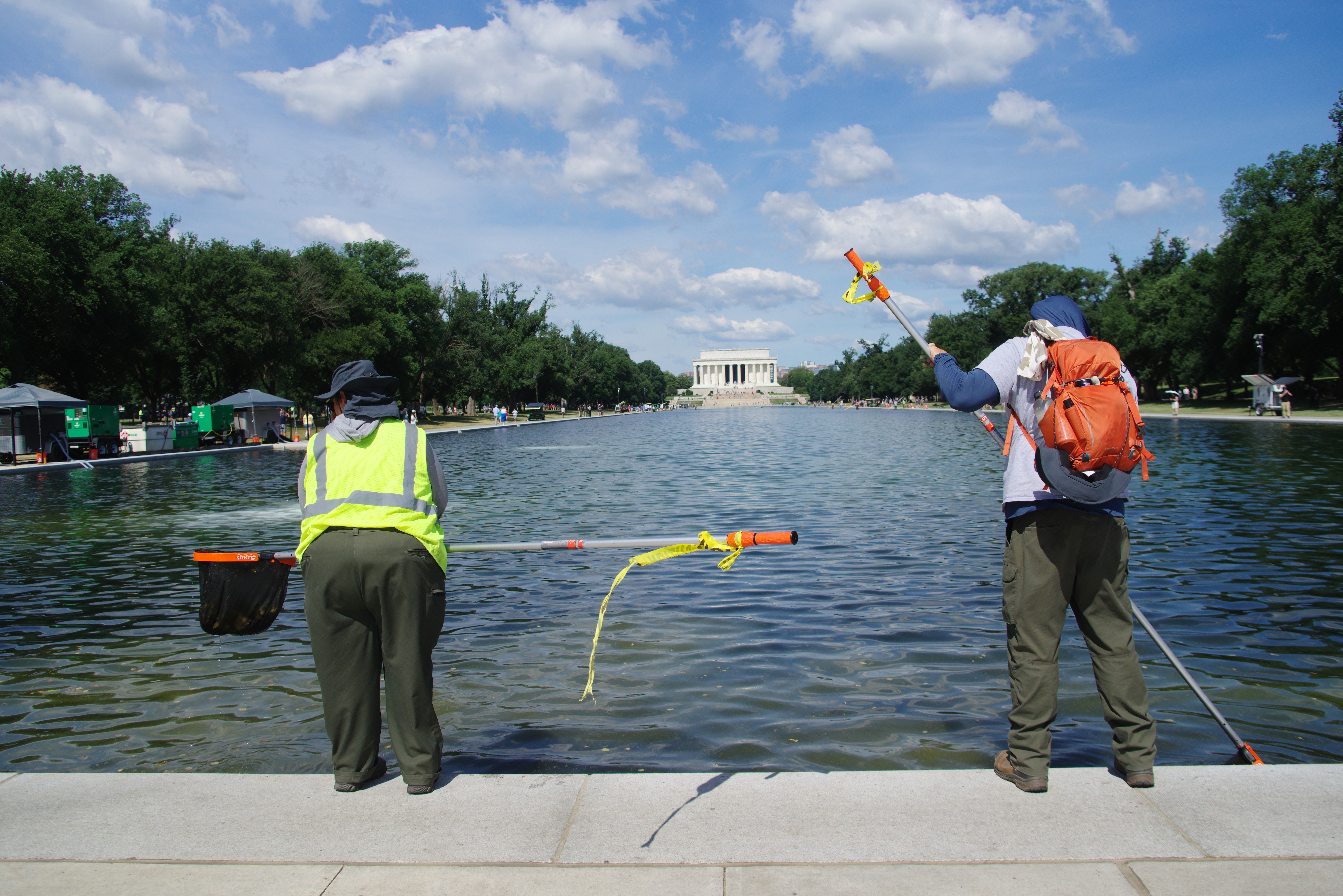 WashingtonDc-June202026WorkersUsePoolStrainers - Kitchen Table News People cleaning the reflecting pool in Washington DC.